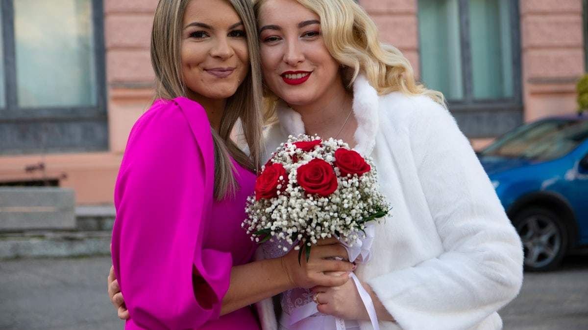 a couple of women holding flowers